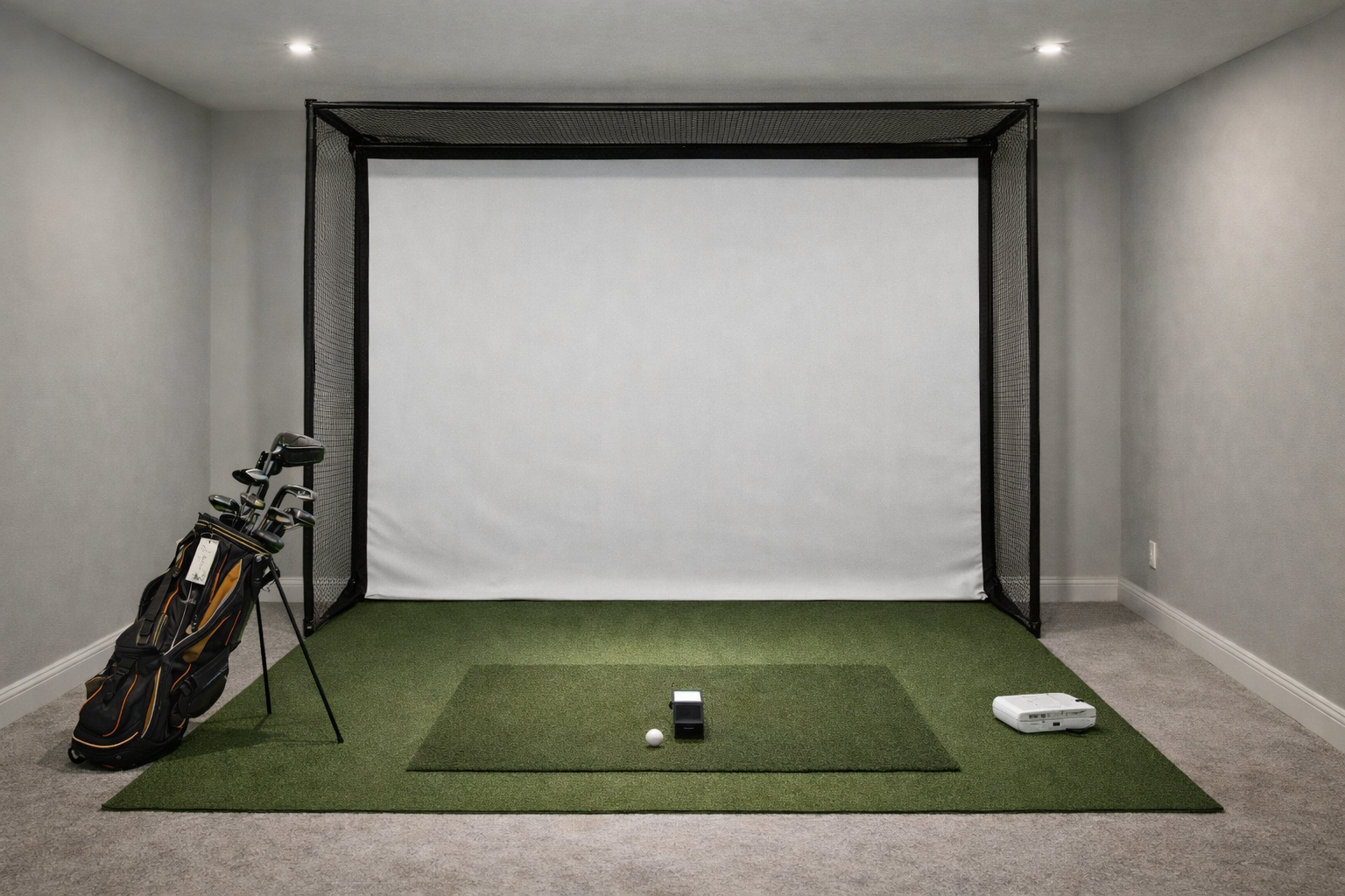Indoor golf enclosure with impact screen, turf, and projector