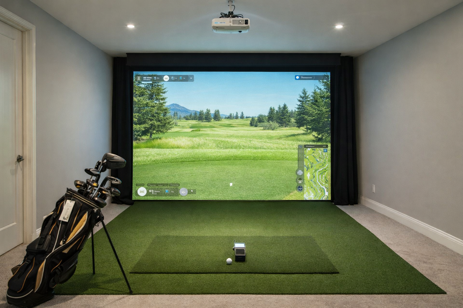 Indoor golf simulator room setup with screen, turf, and ceiling-mounted projector